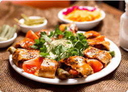 Side view of chicken kebab on lavash served……